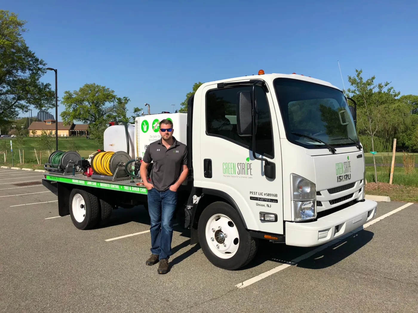 GreenStripe founder Mike Fabian standing beside the first GreenStripe lawn-care truck, lettered Union, NJ