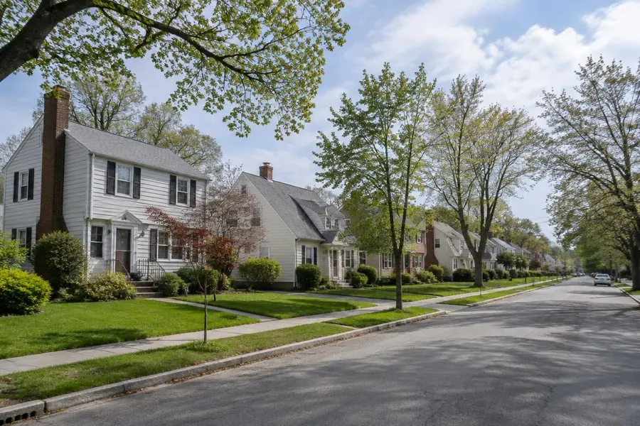 Classic neighborhood street of colonials and capes with evenly sized front lawns in Union, NJ