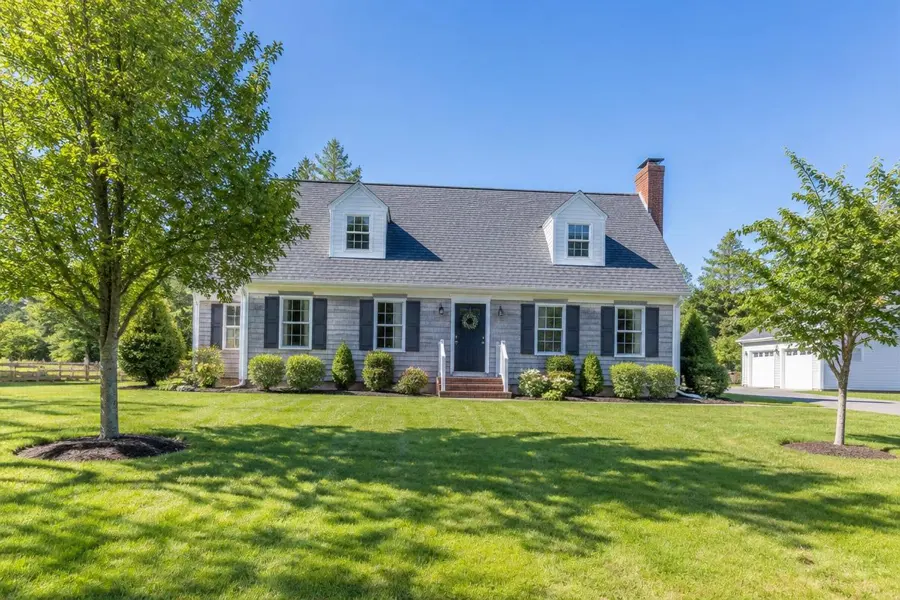 Open, sunny front lawn at a Cape Cod home with few trees in Union, NJ