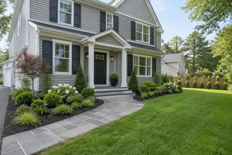 Renovated home with a new stone walkway, fresh landscaping and an existing lawn in Kenilworth, NJ
