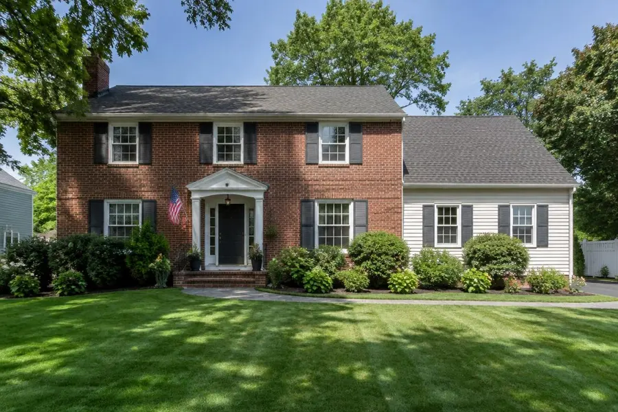 Brick colonial home with a thick established front lawn in Union, NJ