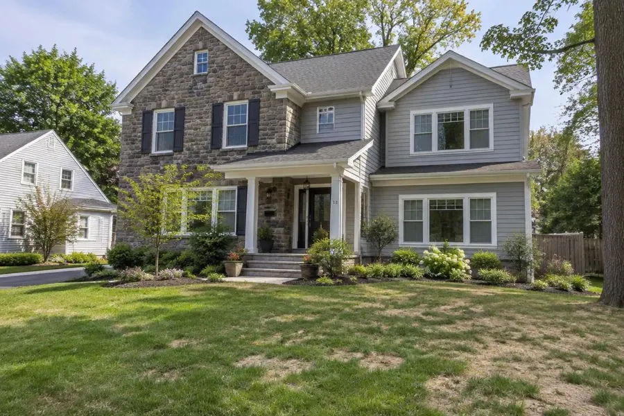 Renovated stone home with a new addition, new landscaping and a thin, recovering lawn in Cranford, NJ