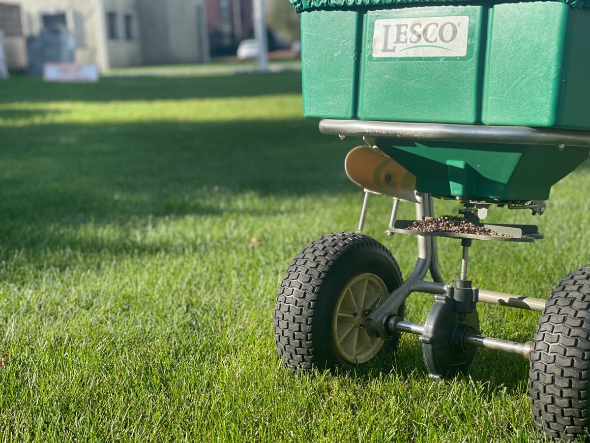 GreenStripe broadcast spreader loaded with no-filler granular lawn fertilizer prills on a thick green New Jersey lawn