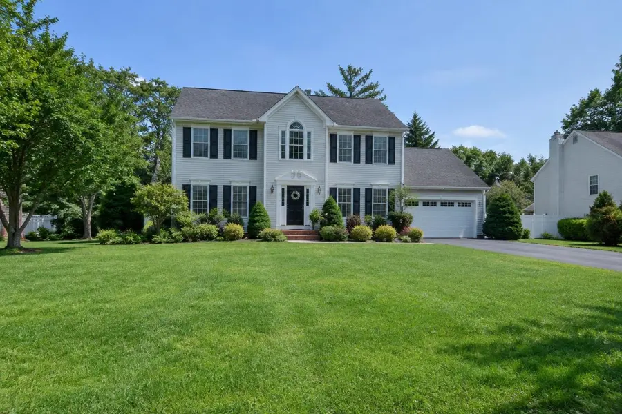 Wide, mostly level green lawn in front of a colonial home in Scotch Plains, NJ