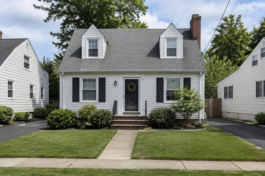 Cape Cod home with a compact front lawn split by a walkway in Garwood, NJ